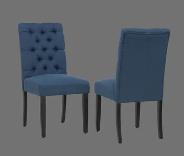 A pair of blue chairs with tufted backs.